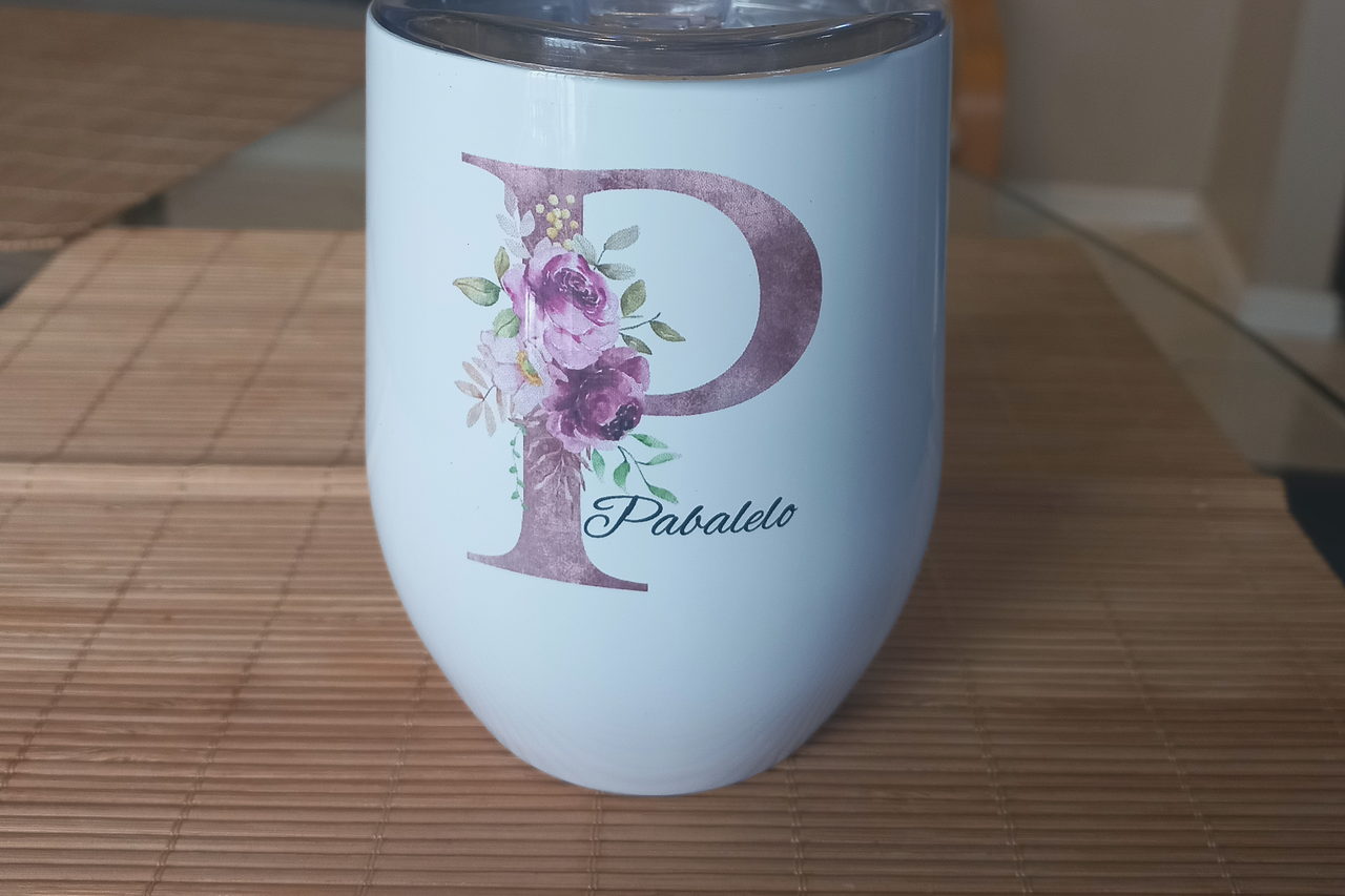 A white personalised tumbler printed with a mauve floral letter P and the name Pabalelo.